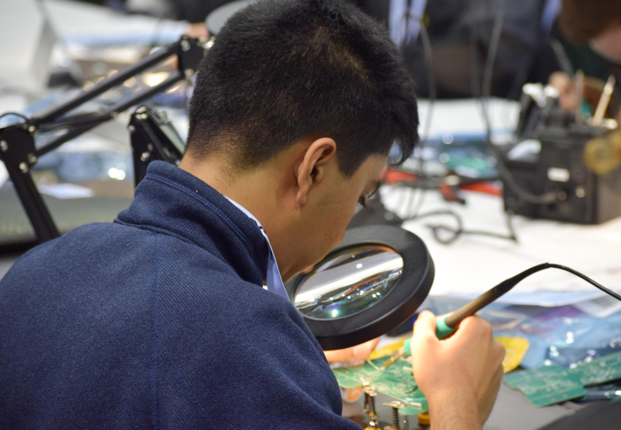 Man working on a PCB robot
