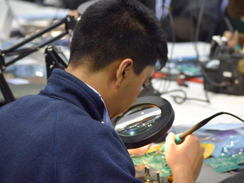 Man working on a PCB robot